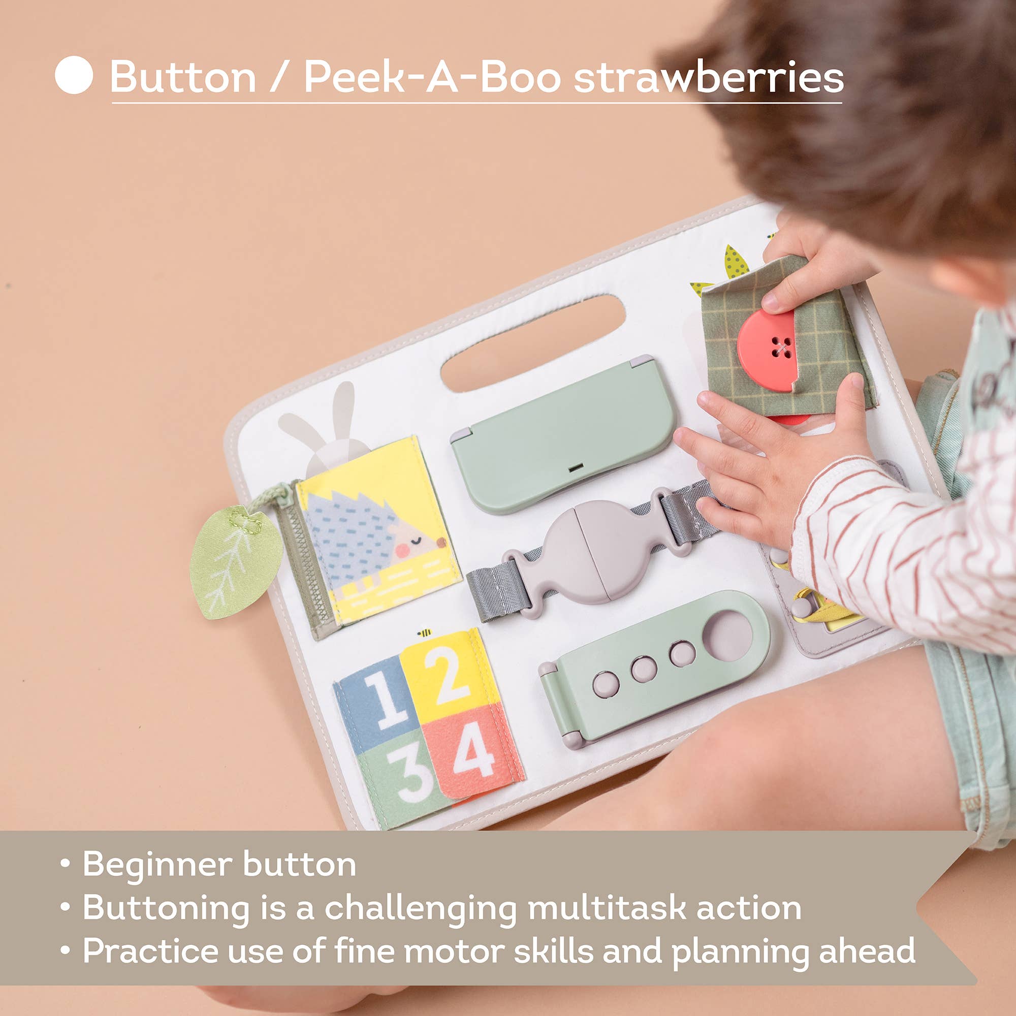 Child playing with a educational toy featuring buttons and a peek-a-boo 