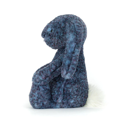 a profile view of a Jellycat blue plush bunny toy on a white background facing the side.
